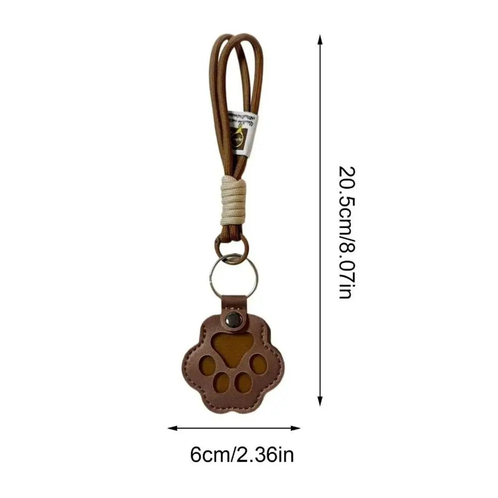 A brown refillable pet hair keychain featuring a cat paw charm.