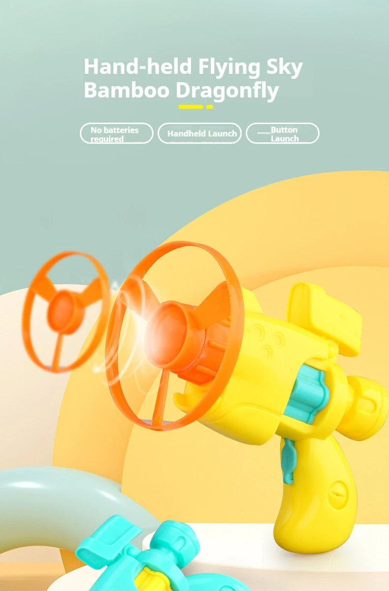 Hand-held flying sky bamboo dragonfly toy launcher in yellow and orange with replacement discs