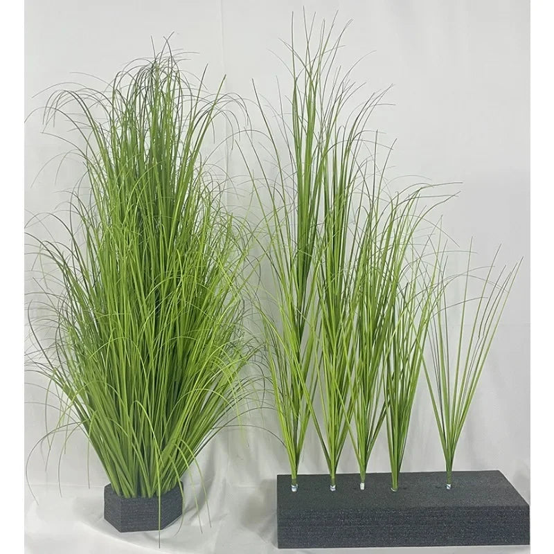 A set of faux grass, reeds, and onion grass plants displayed in black pots.