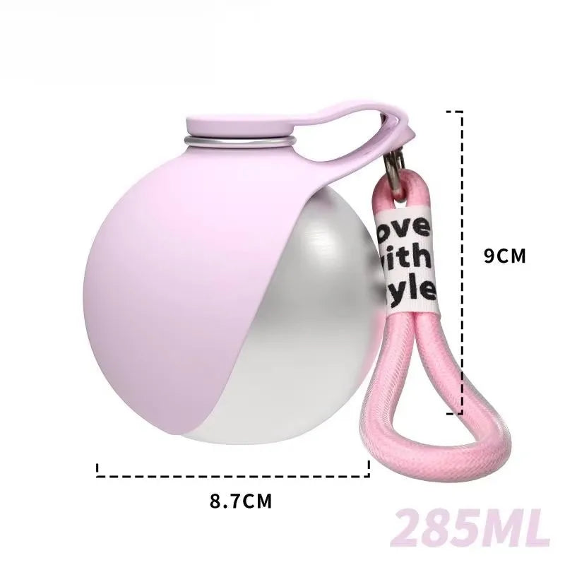 A pink portable stainless steel dog water bottle with a built-in bowl and a pink carrying loop.