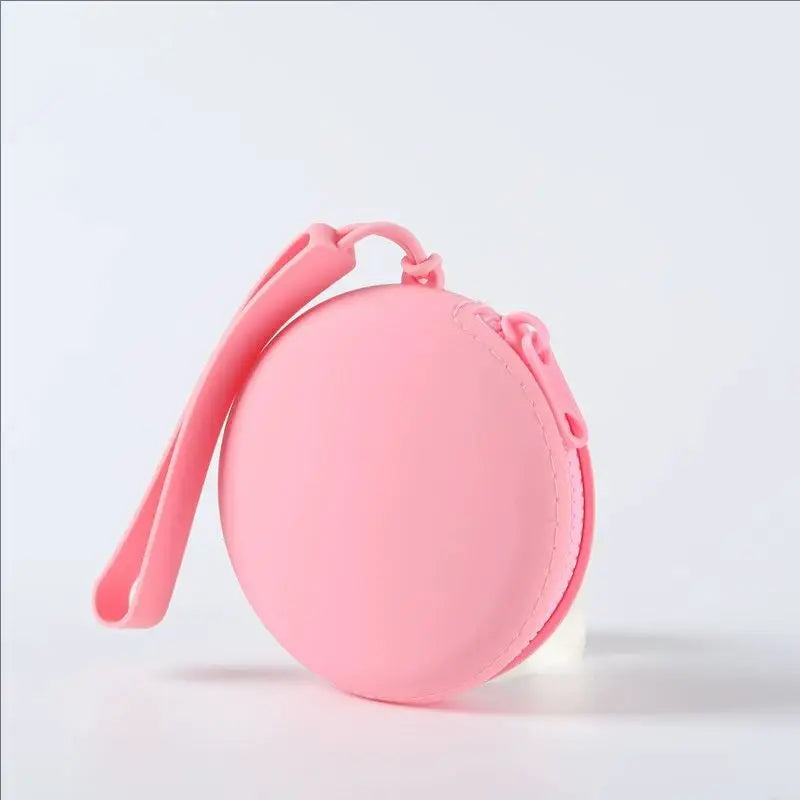 A pink silicone pet treat pouch with a strap is shown against a white background.