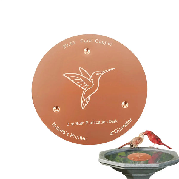 A round copper purification disk with a bird silhouette, shown next to a bird bath.