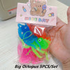 A set of five colorful rubber octopus bath toys with a pink and yellow label is shown in a clear plastic bag.