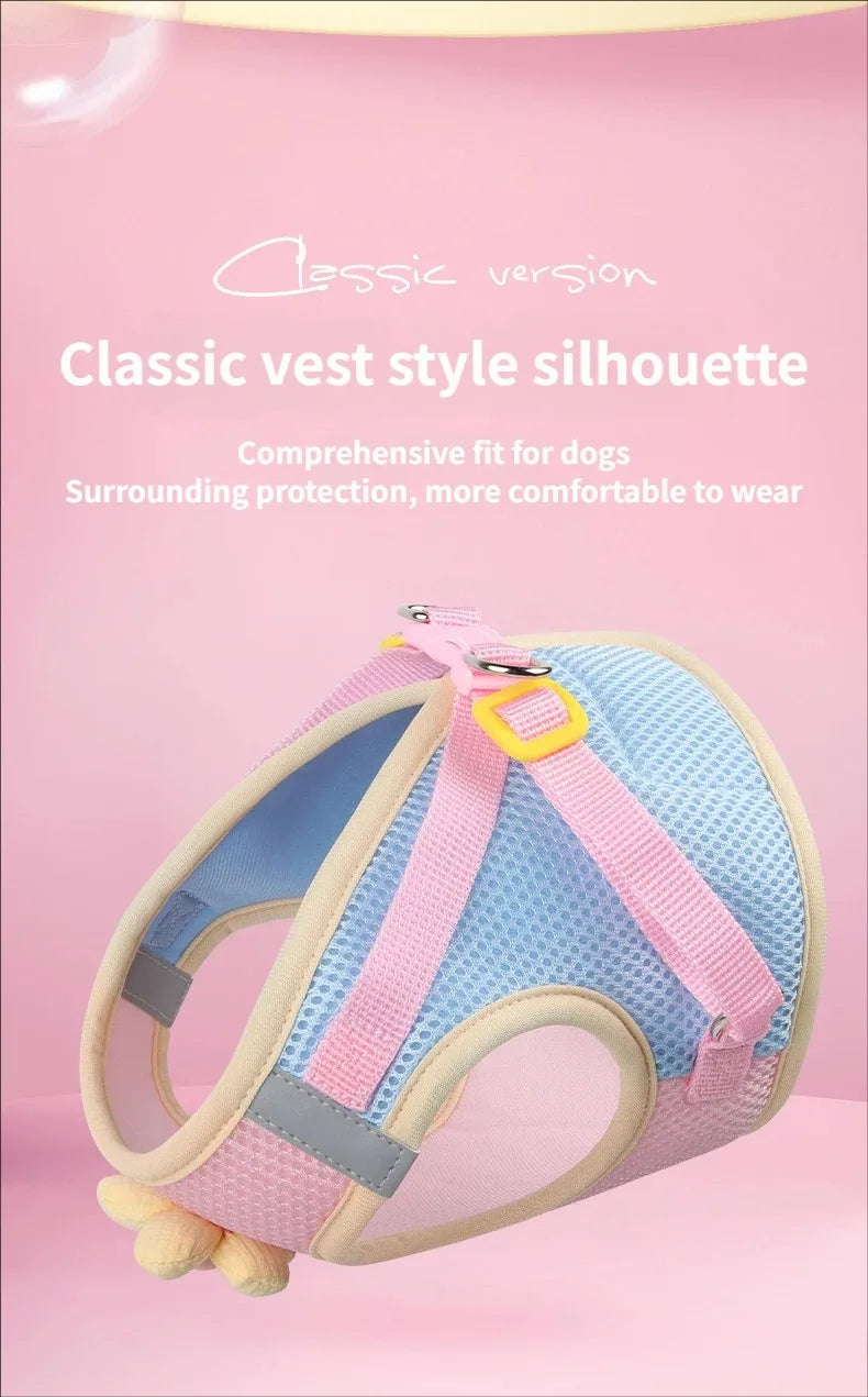 Pink and blue classic vest style dog harness shown against a pink background.