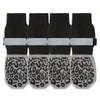 A pack of four black anti-slip cotton dog socks with adjustable grip and leopard print bottoms.