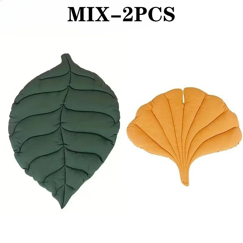 Two reversible leaf-print pet cushions, one dark green and one orange, with quilted texture.