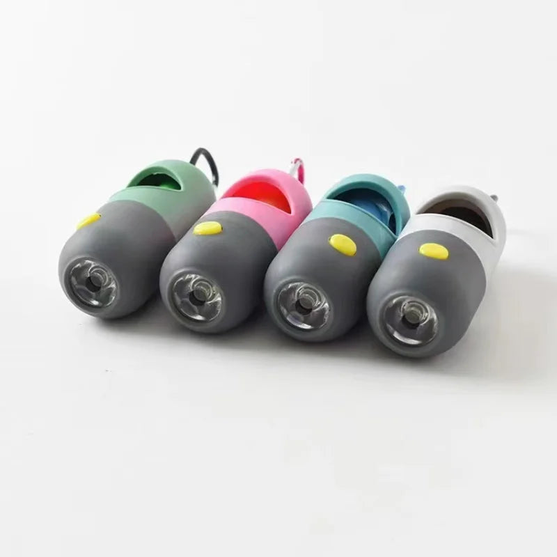 A collection of five colorful capsule dog waste bag dispensers with LED flashlights arranged horizontally.