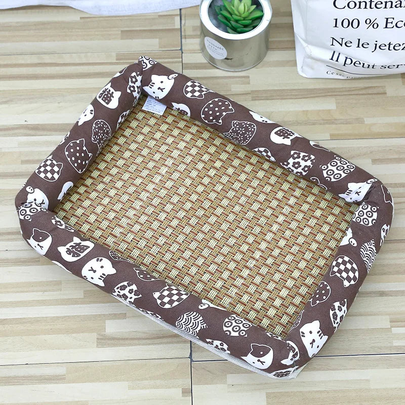 A brown patterned pet bed with a woven cotton mat is shown on a wooden surface.