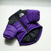 A purple and black quilted winter coat for a dog, shown flat against a white background.