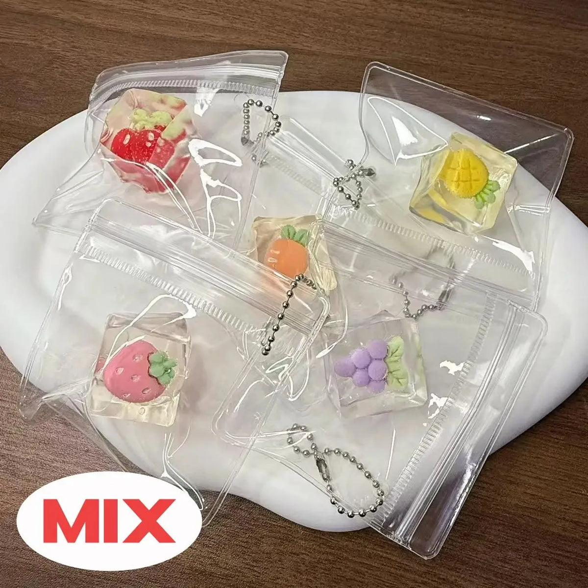 Clear plastic bags containing various squishy bread fidget toys and jewelry items on a white plate