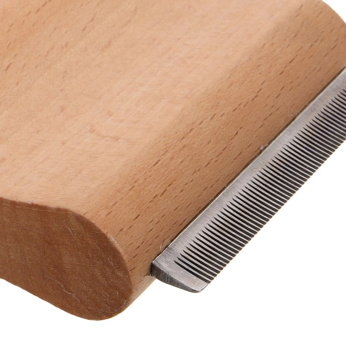 A wooden horse grooming brush with a stainless steel scraper shown in close-up.