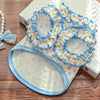 A light blue floral vest for dogs and cats with ruffled trim and a matching fabric bottom.
