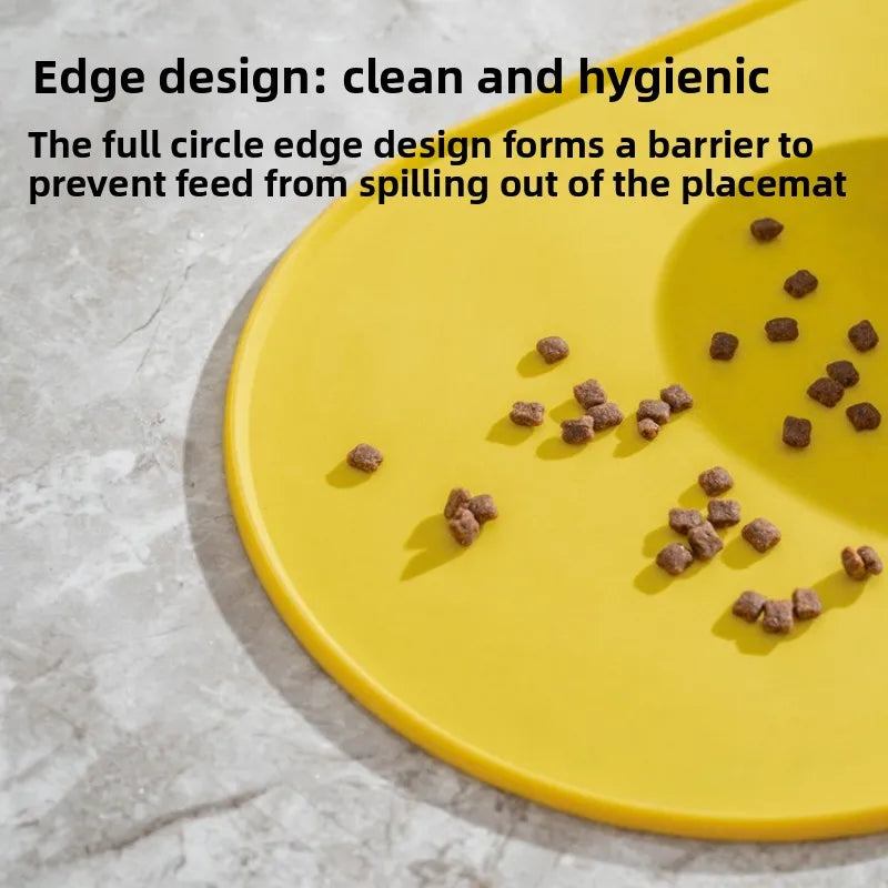 A bright yellow feeding mat with a full circle edge design, showing scattered dry pet food on the surface.