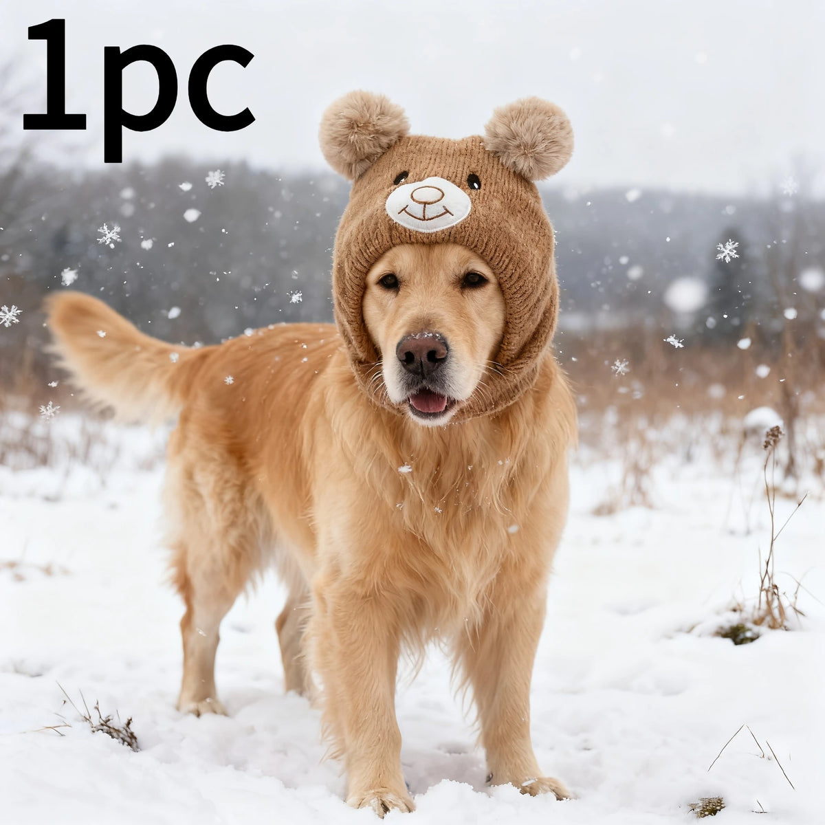A golden retriever wearing a knitted brown winter hat with bear ears in a snowy outdoor setting.