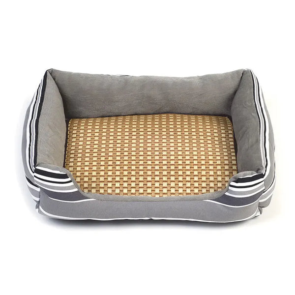 A rectangular pet bed mat with gray fabric sides and a woven tan mat insert.
