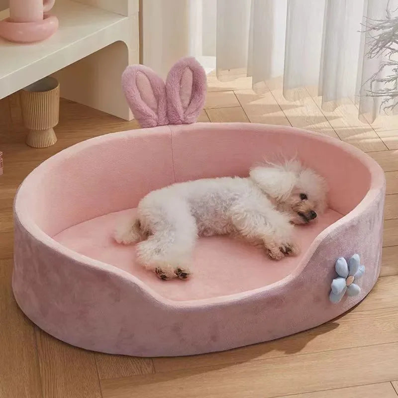 A pink plush pet bed with a removable cover is shown, featuring a white fluffy dog resting inside.