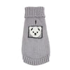 A light gray knitted sweater for a dog featuring a black embroidered face design.