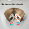A beige accordion-style cat scratching board featuring orange paw prints on the exterior.