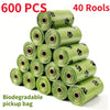A stack of 600 biodegradable pet waste bags in green, packaged in 40 rolls.
