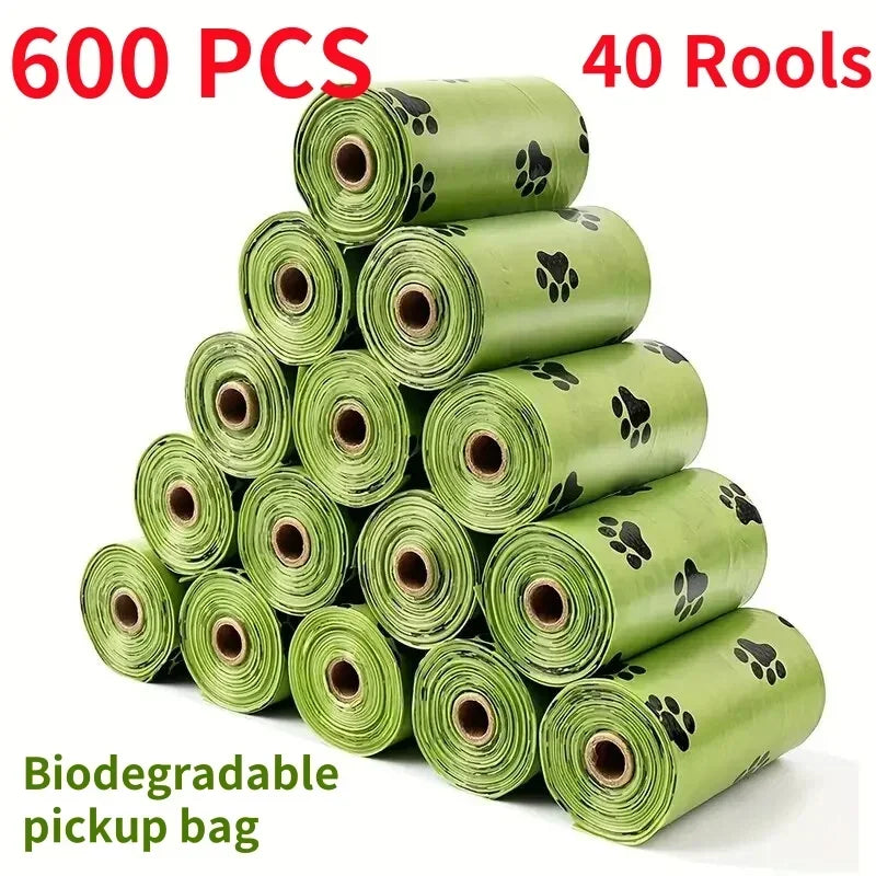 A stack of 600 biodegradable pet waste bags in green, packaged in 40 rolls.
