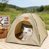 A beige breathable pet tent bed for cats is shown outdoors on a checkered blanket.