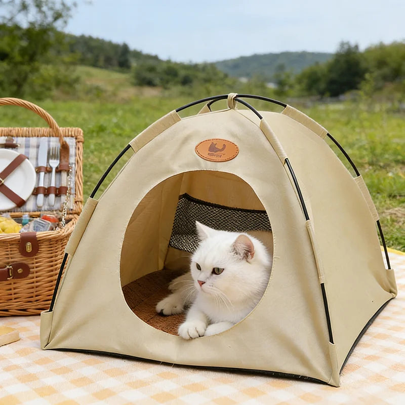 A beige breathable pet tent bed for cats is shown outdoors on a checkered blanket.