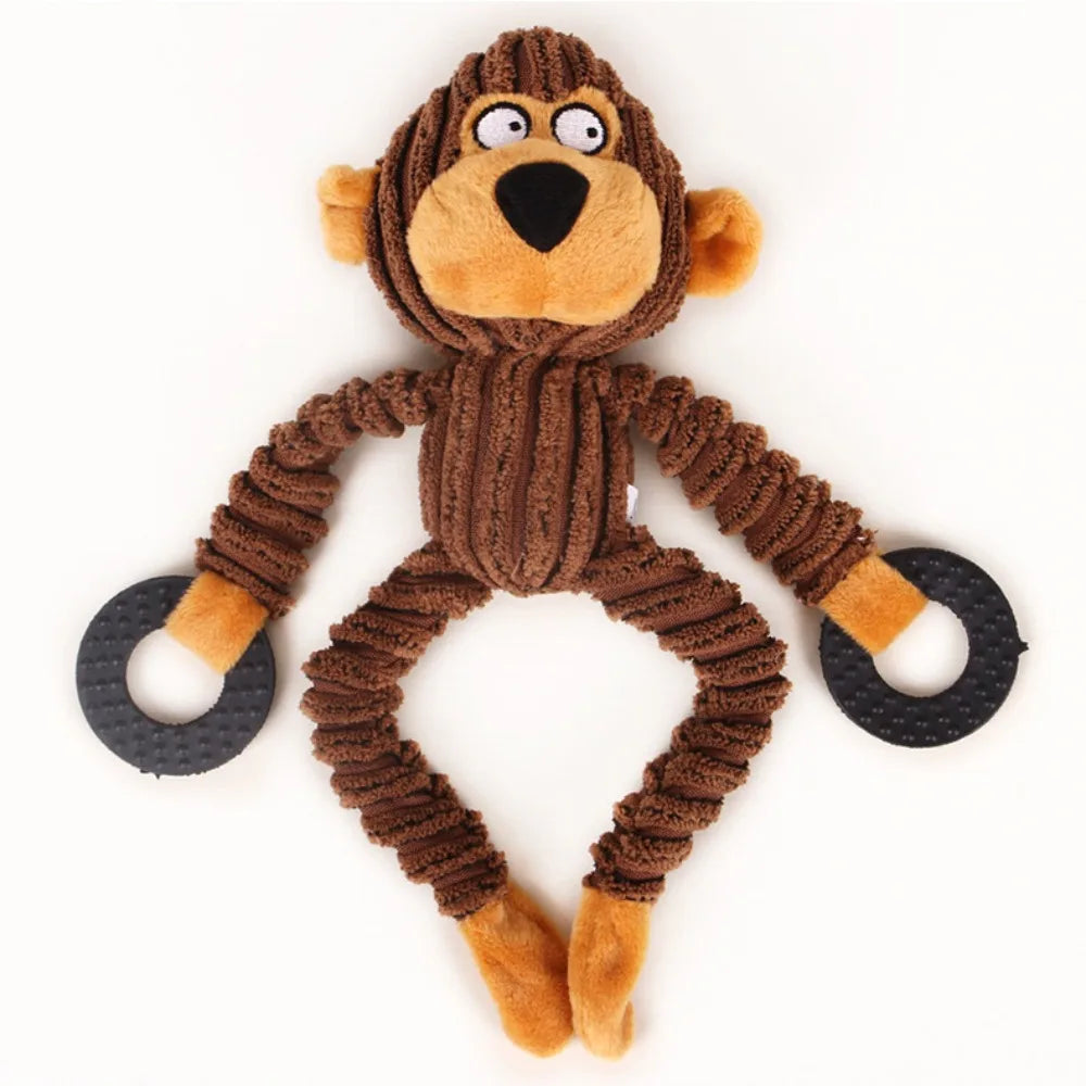 A brown plush toy resembling a monkey with large eyes and orange paws.