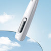 A white portable dog grooming trimmer is shown against a bright blue sky with clouds.
