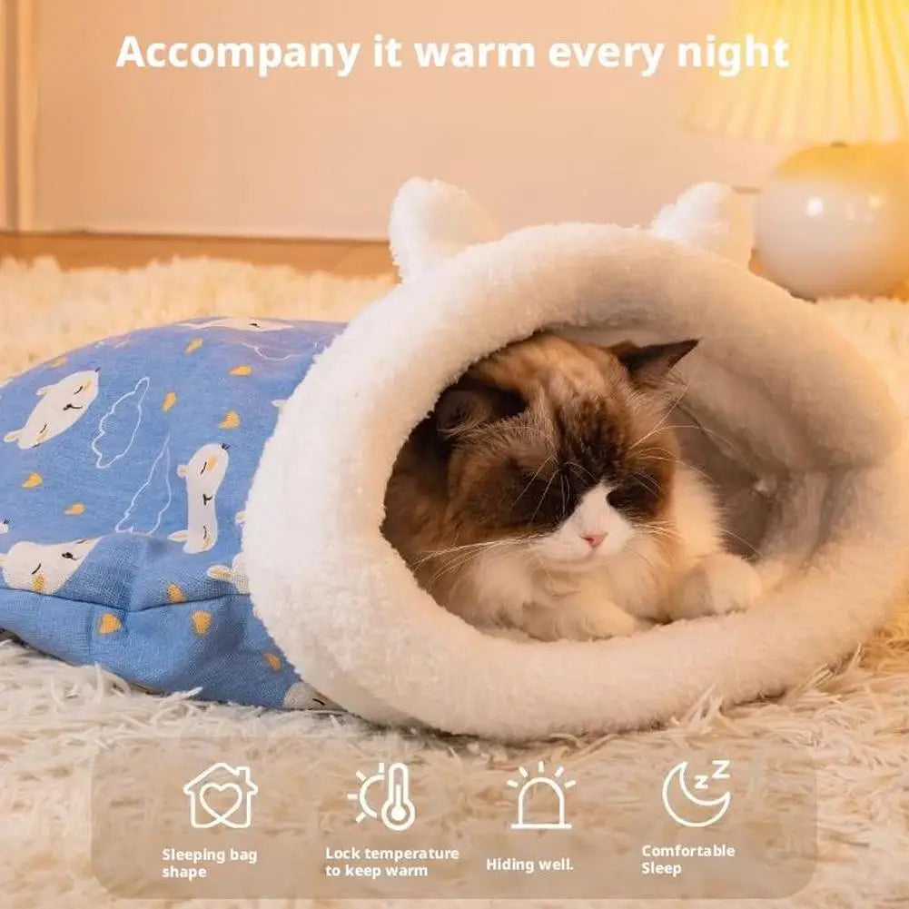 A fluffy white sleeping bag shaped like an animal provides a warm tunnel hideaway for a small cat.