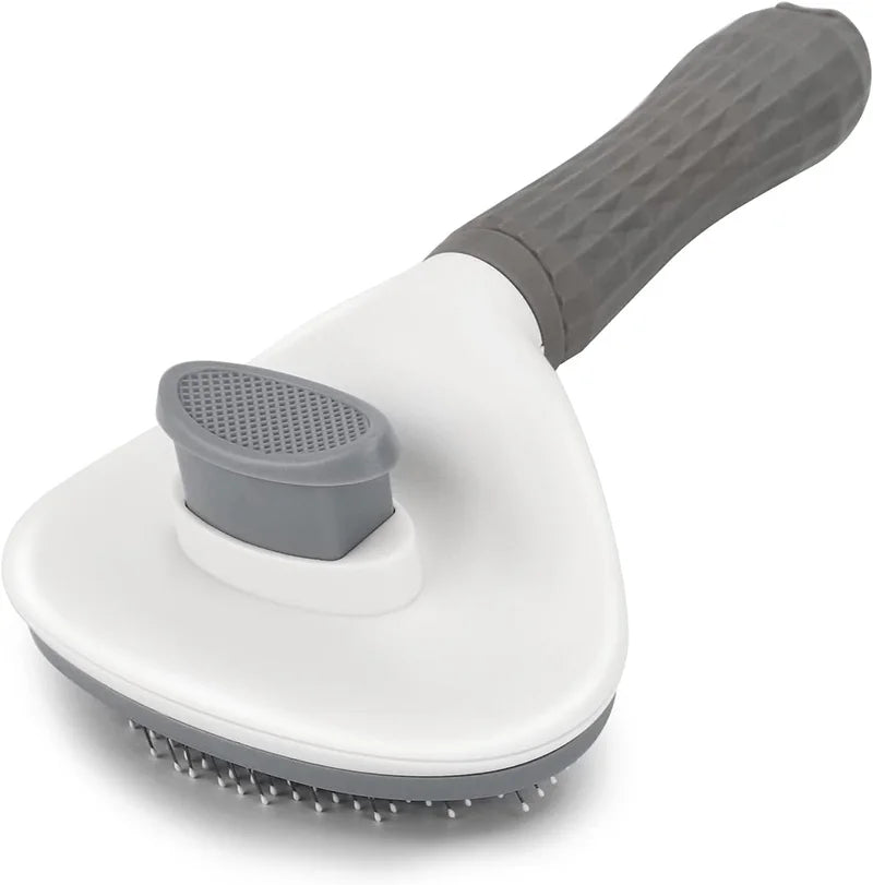 A white pet grooming brush with a gray handle and bristles is shown from above.