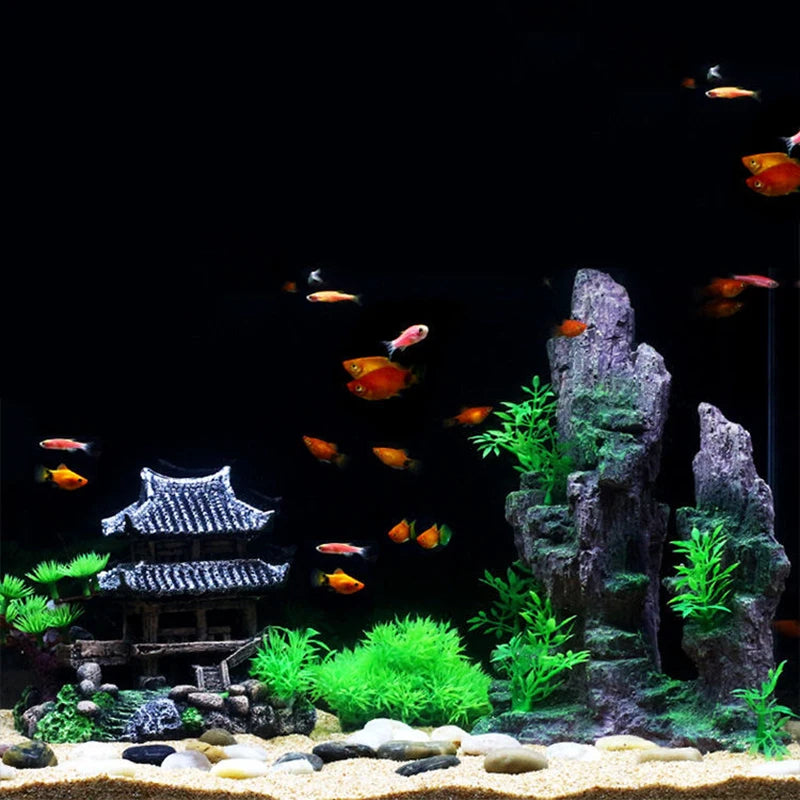 Resin aquarium rockery featuring a cave, trees, and various colored fish