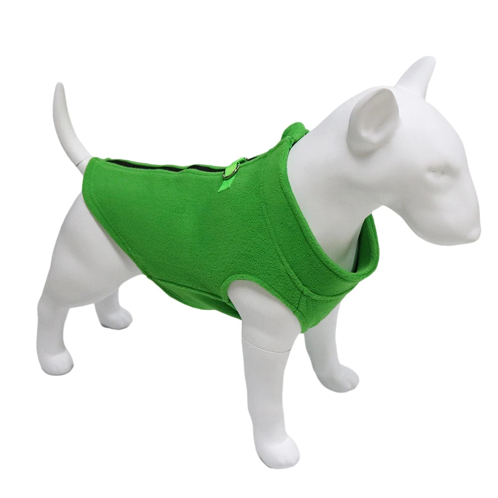 A white dog model wearing a bright green soft fleece vest.