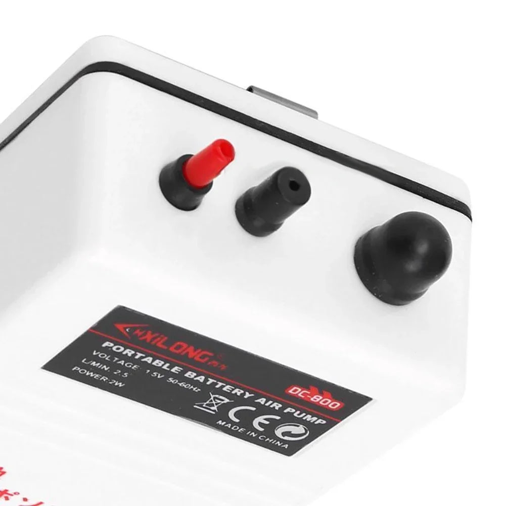 A white portable battery air pump with three black buttons and a silver switch.