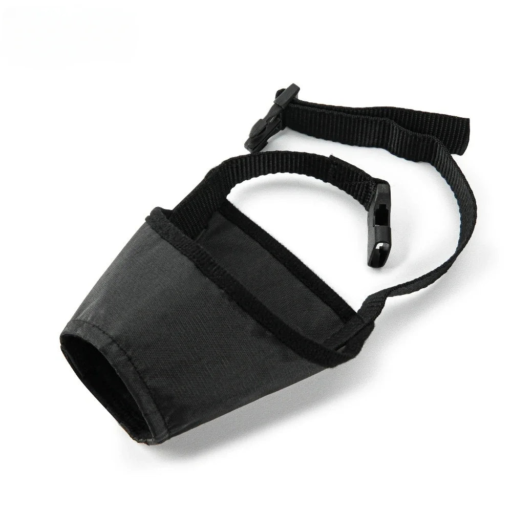 Black soft nylon dog muzzle with a safety buckle and adjustable strap.