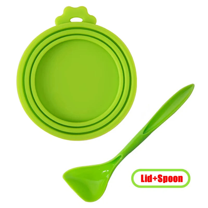 A bright green reusable silicone pet food can lid with a matching spoon.