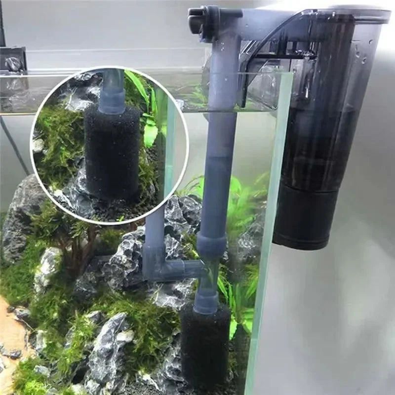 A close-up view of an aquarium intake pre-filter system with black sponges and tubing mounted on a glass display.