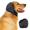 A golden retriever is wearing a black noise-reducing ear muff for dogs.