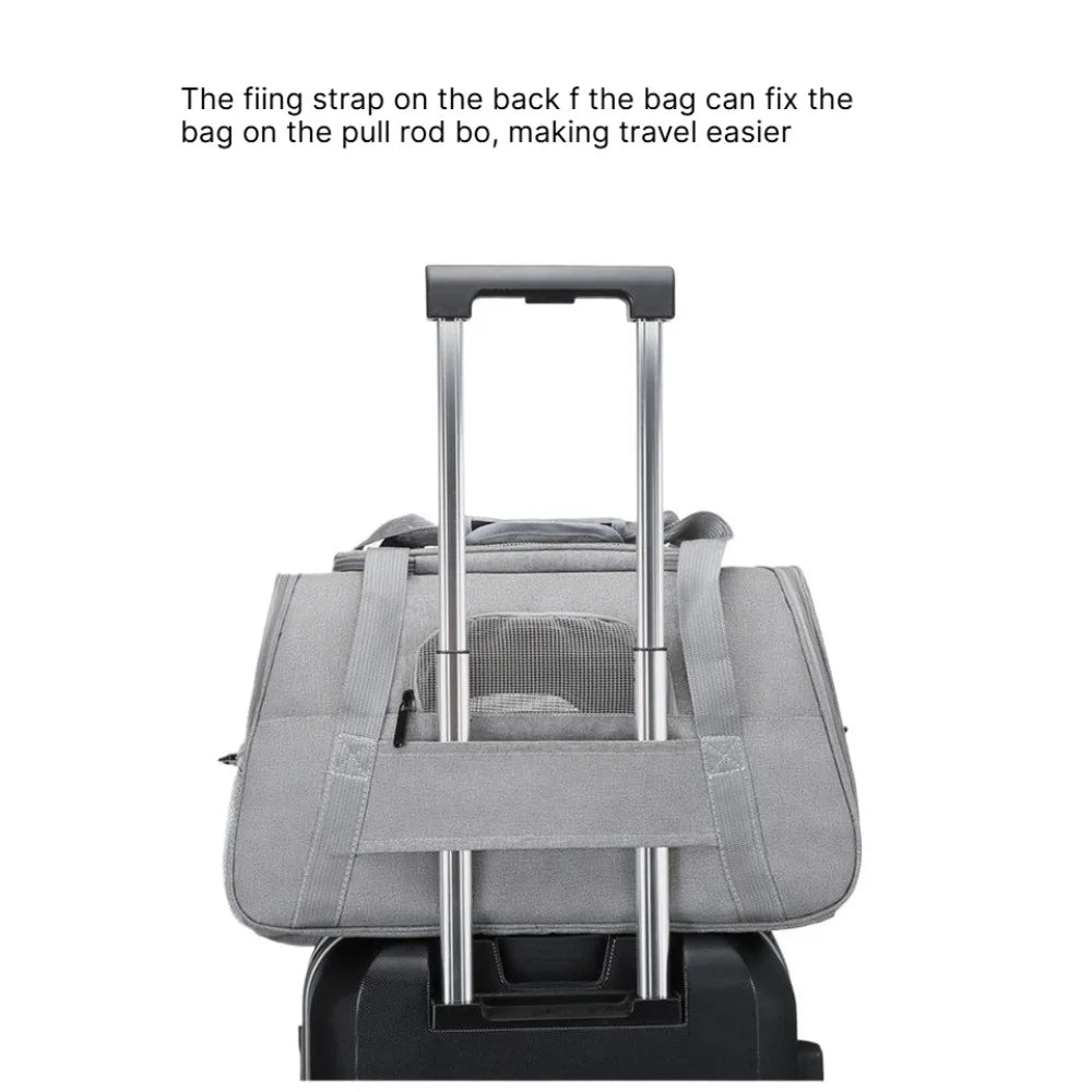 A gray foldable pet travel carrier bag with a handle is shown on a rolling frame.
