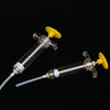 A clear plastic syringe with a yellow plunger and soft hose is shown against a black background.