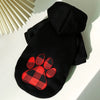 Black reversible plaid dog jacket with a cozy fleece lining displayed on a white surface.