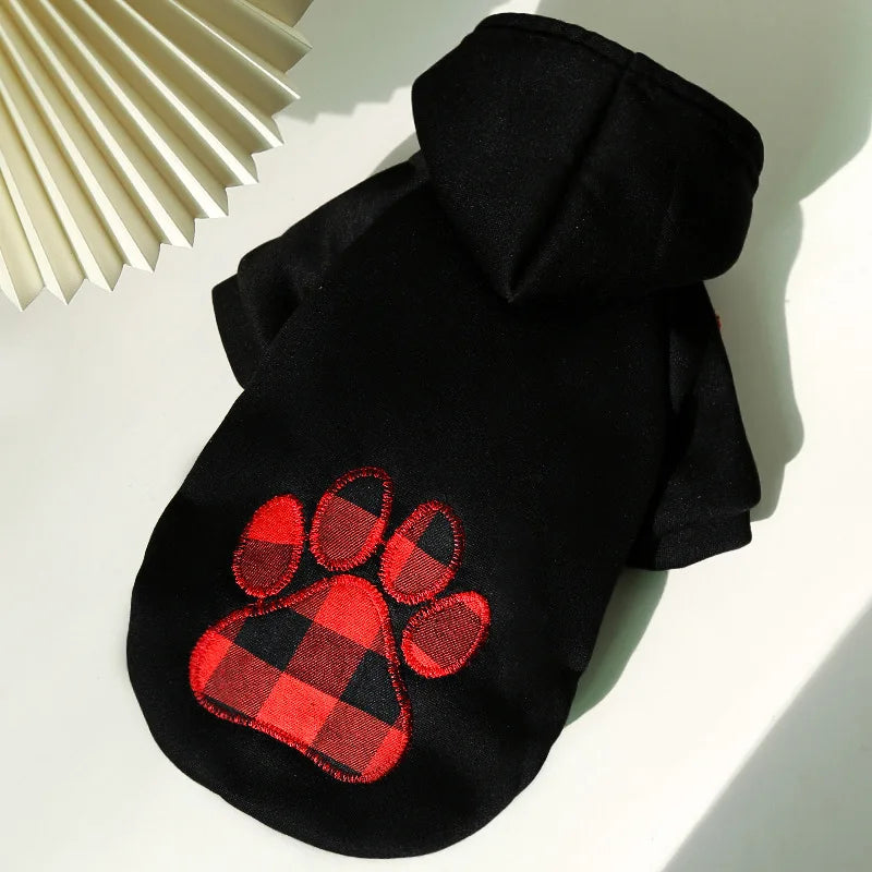 Black reversible plaid dog jacket with a cozy fleece lining displayed on a white surface.