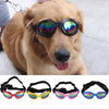 A collection of five colorful pet sunglasses for dogs, including pink, yellow, and blue frames.