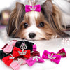 A small dog wearing a pink and purple glitter bow hair clip on its head.