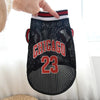 A black basketball vest with red and white trim featuring the word CHICAGO and the number 23.