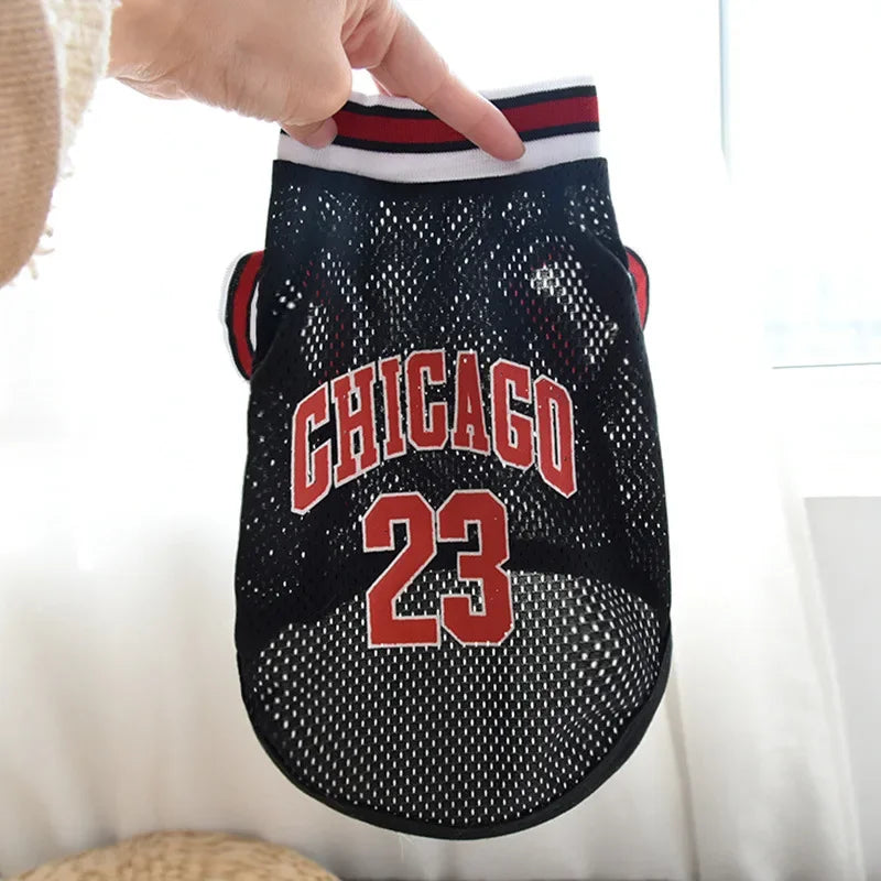 A black basketball vest with red and white trim featuring the word CHICAGO and the number 23.