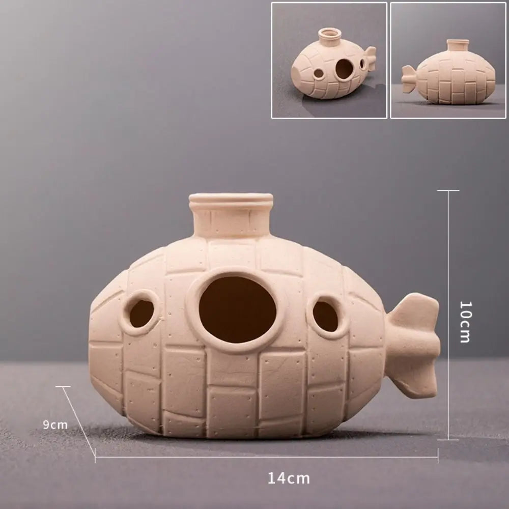 A light beige ceramic aquarium shrimp hideaway cave with various openings and textured surface.