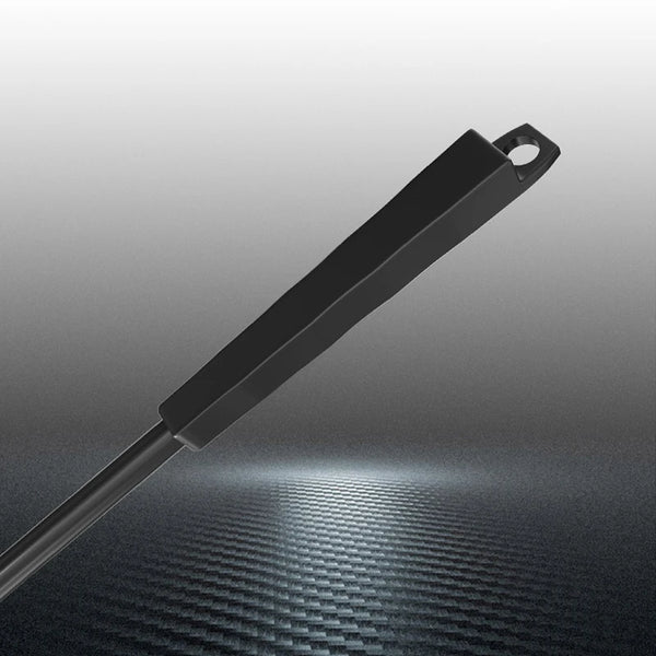 A long, black dual-use aquarium algae scraper with a handle is shown against a dark, textured background.