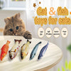 A collection of soft, realistic fish-shaped toys for cats displayed on a wooden surface.