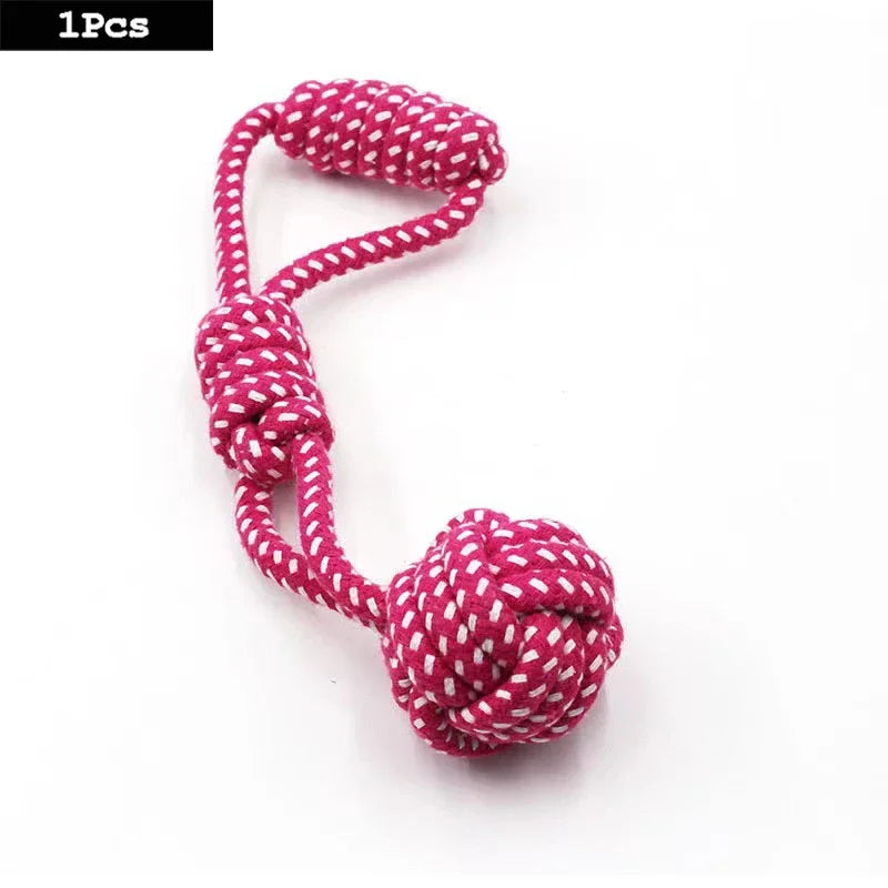 A single pink and white patterned cotton rope toy made in the shape of a carrot or dumbbell.