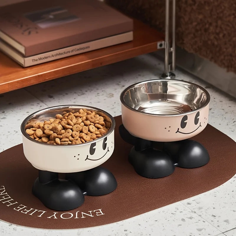 A beige elevated stainless steel pet feeder with a no-spill design sits on a brown mat.